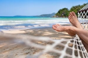 woman feet in hammock on beach