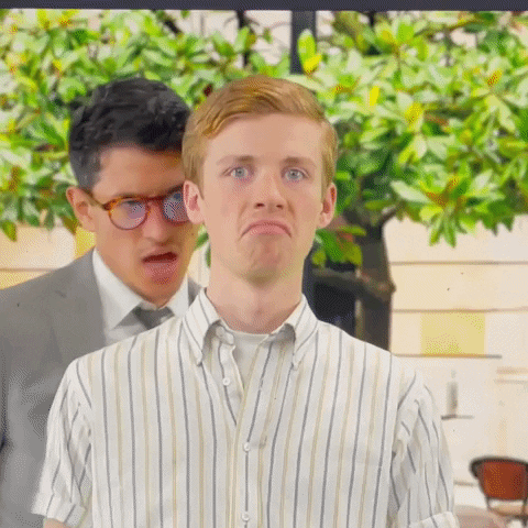 gif of a man with people speaking in his ears from all directions